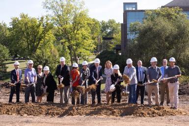 Members of Doane University's Leadership Team, Clark & Enersen and Sampson Construction participate in a groundbreaking ceremony for the university's newest residence hall. Sampson Construction provided shovels and hardhats for the event. 